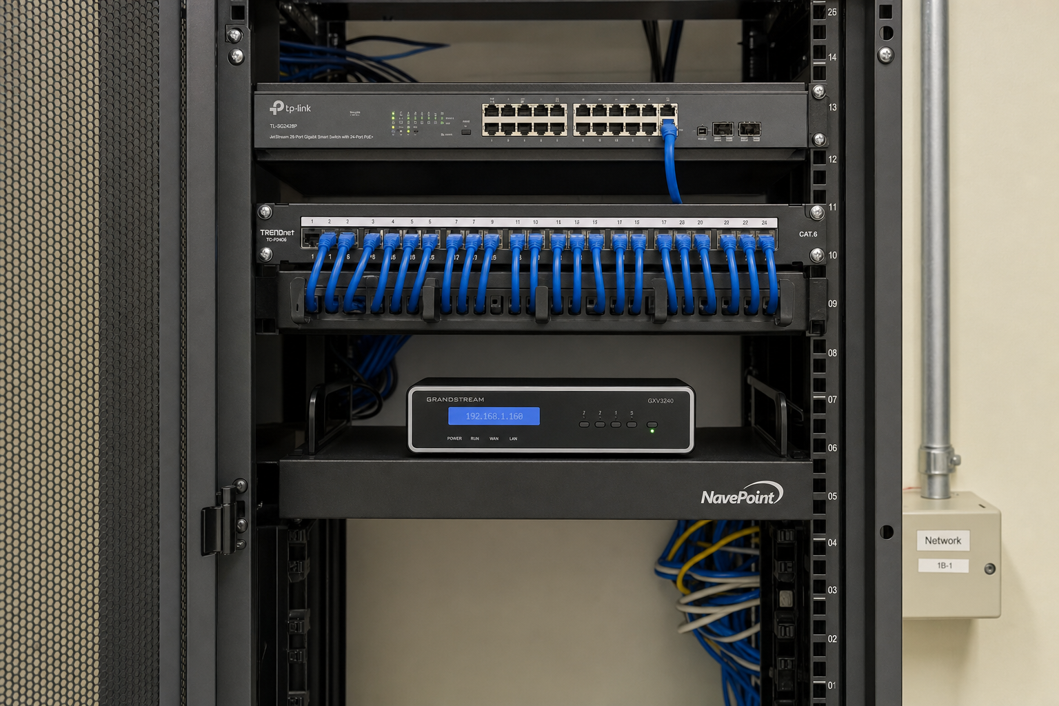 Organized network closet with managed switch and patch panel supporting a Florida business VoIP phone system