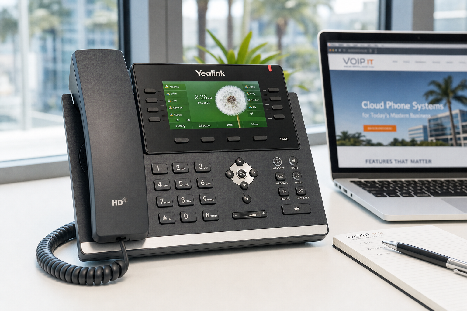 VoIP desk phone on a Florida business office desk next to a laptop and notepad